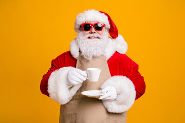 Portrait of nice attractive cheerful confident Santa father shop owner businessman entrepreneur drinking cappuccino rest relax pause break isolated bright vivid shine vibrant yellow color background