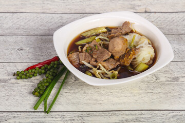 Thai style soup with meat and mushrooms