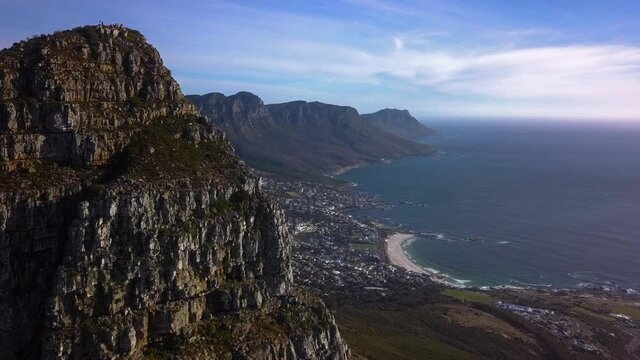 Spectacular fly past Lions Head Mountani Peak to reveal The Twelve Apostles and Affluent Coastal Suburb on a clear day Sea Point, Cape Town South Africa, Drone Aerial
