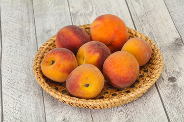 Peach heap in the wooden basket