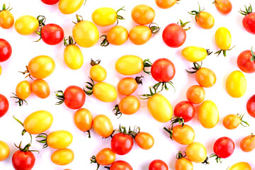 Fototapeta na wymiar Red and yellow cherry tomatoes isolated on white background. Food background top view. Place for text