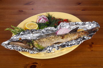 Stuffed baked pike with lemon
