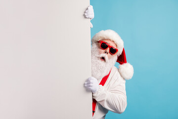Portrait of his he nice attractive funky amazed astonished wondered white-haired Santa holding copy empty blank place space novelty isolated over bright vivid shine vibrant blue color background