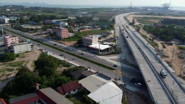 Fly over nearly complete bridge construction and highway to deep Thai seaport