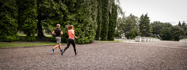 Banner young couple run in the park. They want living healthy lifestyle.