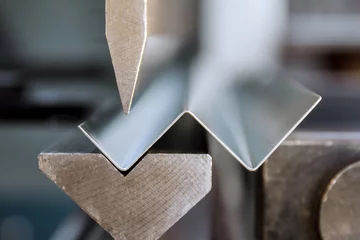 Foto auf Acrylglas Bending of galvanized sheet metal on a hydraulic bending machine at the factory. © Yaroslav