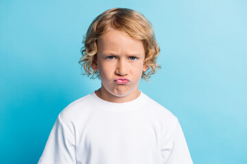 Photo of small boy with grimace face feel disappointed wear white t-shirt isolated over blue color background