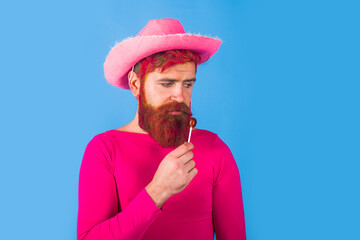 Gay. Gay with lollipop. Portrait of gay cowboy. Man wearing cowboy hat. American bandit. Western...