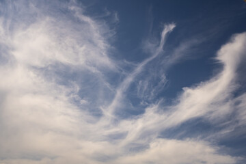 Blue sky background with white striped clouds. Clearing day and Good windy weather