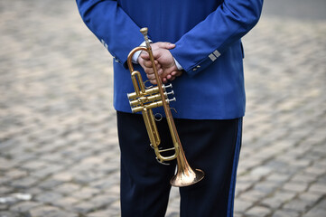 Fototapeta na wymiar Military orchestra man performing during ceremony. Detail with musician hands playing on trumpet.