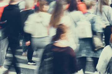 Blurred crowds of people walking around the city