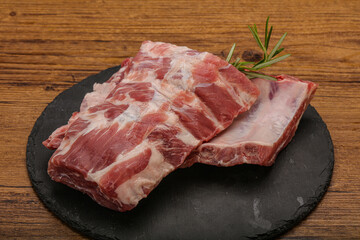 Raw pork ribs served rosemary