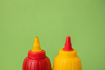 mustard pot and ketchup pot on color background