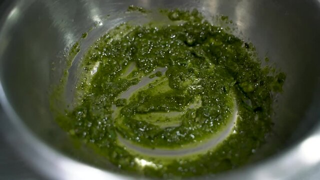 Green Sauce Puree In A Silverware Bowl Stir By A Spoon Prepared To Use For Chermoula Chicken Recipe. - Close Up Shot