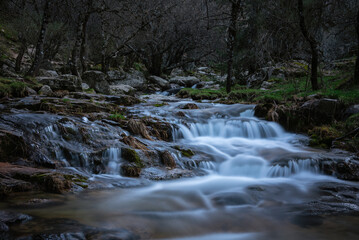 River water flows among the rocks and forms small waterfalls, Rascafría, Madrid, Spain