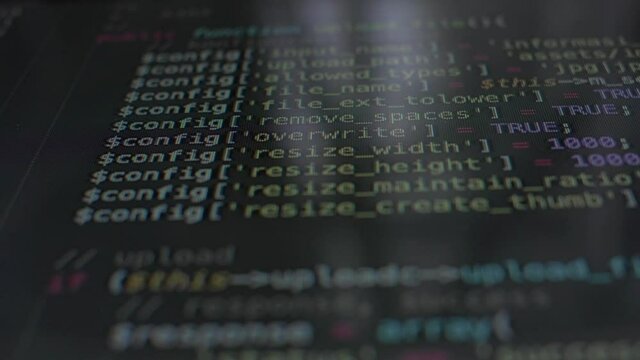Down top shot of programming source code on black screen. Code written by programmer. Silicon Valley. On-screen programming code.