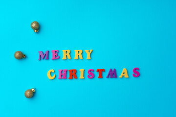 Words Merry Christmas on blue background top view