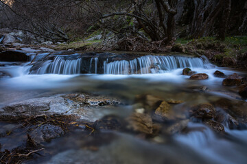 River water flows among the rocks and forms small waterfalls, Rascafría, Madrid, Spain