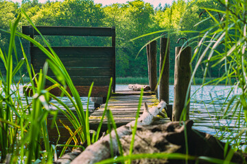 Wooden fishing jetty on a small forest lake