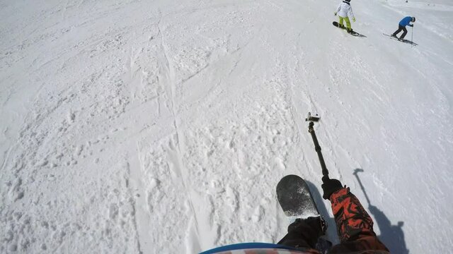 FPV boarder with action cam on monopod slides down and makes comment to another