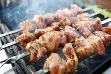 Cooking pork neck on skewers