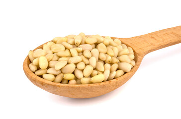 wooden spoon with pine nuts isolated on white