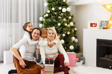 Happy family playing with Christmas gifts at home