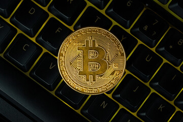 gold bitcoin on the keyboard.