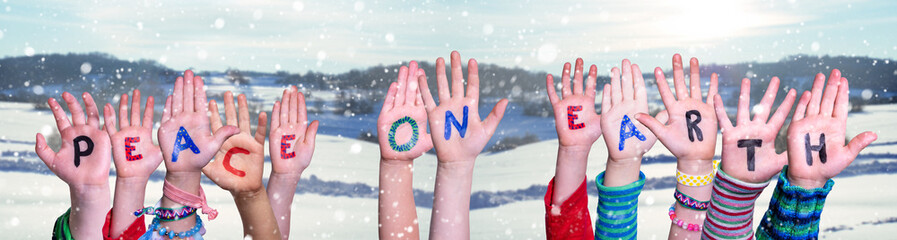Children Hands Building Colorful English Quote Peace On Earth. Snowy Winter Background With...