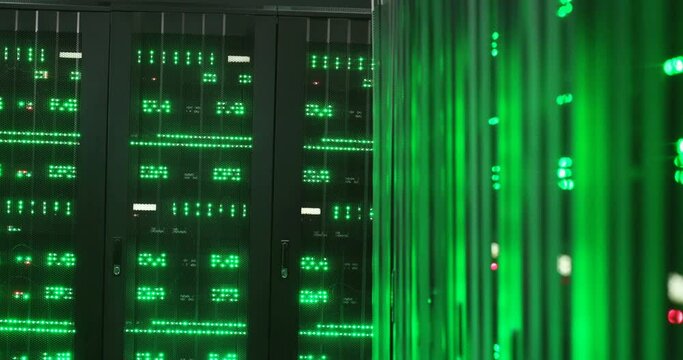 Close up of computers processors with green lights working in dark server room. Storage of digital online information. Database of internet programs. Mining computer. Data center. Security concept.
