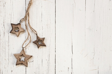 Wooden stars for Christmas Tree over white wooden background