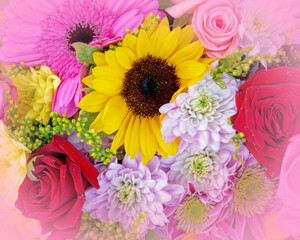 soft and airy sunflower, chrysanthemums and roses bouquet top view, filtered image