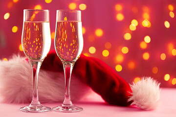 Christmas and New Year concept with two glasses of champagne against bokeh lights