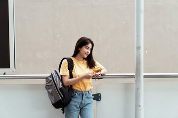Obraz na płótnie Canvas University student holding a smartphone.