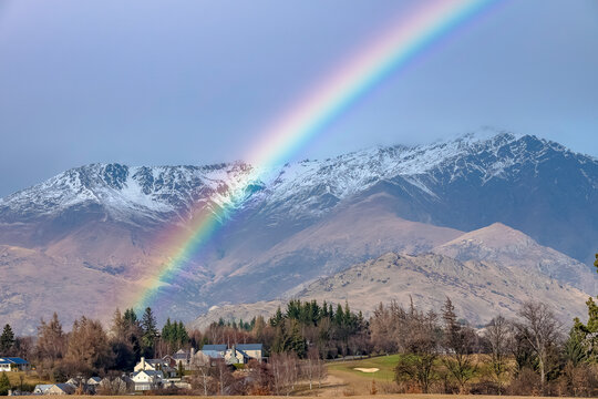 Bright rainbow in the mountains of Queenstown, New Zealand