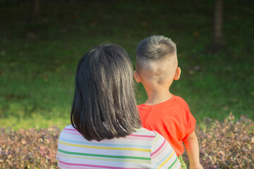 Asian mother and child, looking forward