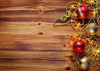 Christmas composition. Christmas red and gold decorations on a wooden background. Flat lay, top view, copy space