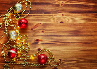 Christmas composition. Christmas red and gold decorations on a wooden background. Flat lay, top view, copy space