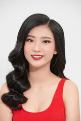 Fototapeta premium Portrait of young beautiful asian girl smiling looking at camera over white background.