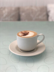 Hot cappuccino cup on table in restaurant