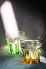 Glass of water on arustic backreound. with lighting effects