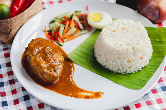 Traditional Malaysian Nasi Dagang fish curry rice food flat lay.