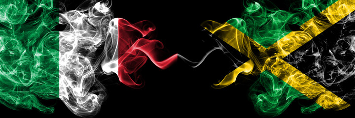 Italy vs Jamaica, Jamaican smoky mystic flags placed side by side. Thick colored silky abstract smoke flags of Italian and Jamaica, Jamaican