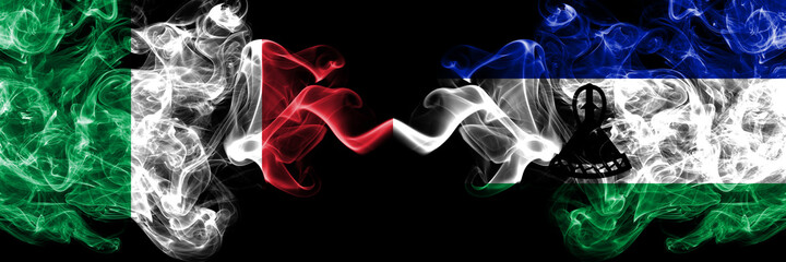 Italy vs Lesotho smoky mystic flags placed side by side. Thick colored silky abstract smoke flags of Italian and Lesotho