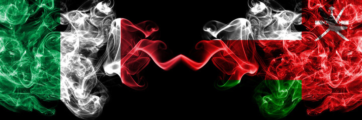 Italy vs Oman, Omani smoky mystic flags placed side by side. Thick colored silky abstract smoke flags of Italian and Oman, Omani