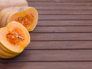 cut pumpkin on a wooden table copyspace