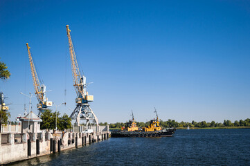 River port of the city of Kherson with cranes and ships.