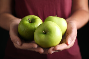 Farmer holding fresh ripe apples, closeup view