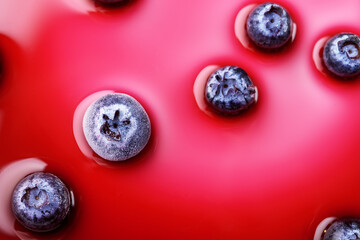 Frozen blueberries in pink syrup.