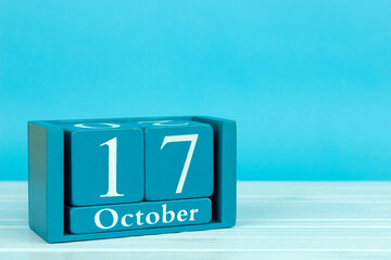 wooden calendar with the date of October 17 on a blue wooden background, World Injury Day; World Day for Organ Donation and Transplantation; International Day for the Eradication of Poverty; Edge Day 